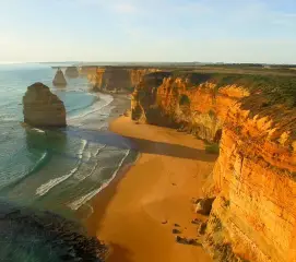 Couples experiencing a romantic sunset along Great Ocean Road on an Australia honeymoon trip from Chennai