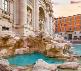 Couples visiting the Trevi Fountain on a romantic Italy honeymoon trip from Chennai